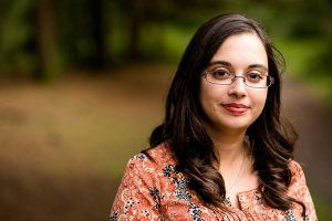 Lucy Henson Clark: a woman with dark hair looking directly at the camera